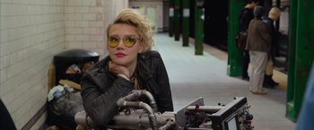 Movie still from “Ghostbusters” (2016), directed by Paul Feig – A woman in a leather jacket and yellow sunglasses; Close Up shot, Over the shoulder angle