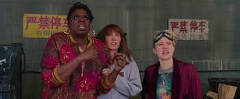 Movie still from “Ghostbusters” (2016), directed by Paul Feig – A group of people standing next to each other; Medium shot, Low angle