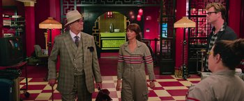 Movie still from “Ghostbusters” (2016), directed by Paul Feig – A man and a woman walking down a hall way; Medium shot, Over the shoulder angle