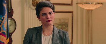 Movie still from “Ghostbusters” (2016), directed by Paul Feig – A woman in a gray jacket is looking at the camera; Close Up shot, Over the shoulder angle