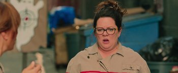 Movie still from “Ghostbusters” (2016), directed by Paul Feig – A person wearing glasses; Close Up shot, Over the shoulder angle