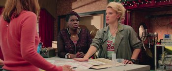 Movie still from “Ghostbusters” (2016), directed by Paul Feig – Two women are sitting at a table with papers; Medium shot, Over the shoulder angle