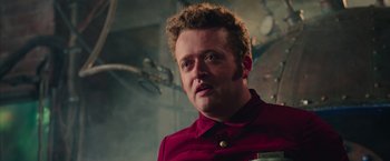 Movie still from “Ghostbusters” (2016), directed by Paul Feig – A person wearing a red shirt; Close Up shot, Low angle