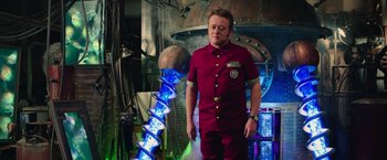 Movie still from “Ghostbusters” (2016), directed by Paul Feig – A man standing in front of an electric tower; Medium shot, Low angle