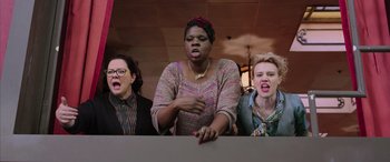 Movie still from “Ghostbusters” (2016), directed by Paul Feig – A group of women standing next to each other in a room; Medium shot, Low angle
