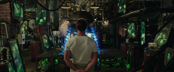 Movie still from “Ghostbusters” (2016), directed by Paul Feig – A man standing in front of an industrial machine; Medium shot, Over the shoulder angle
