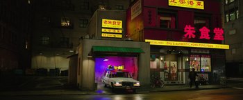 Movie still from “Ghostbusters” (2016), directed by Paul Feig – A car is parked in a parking garage at night; Extreme Wide shot, Low angle