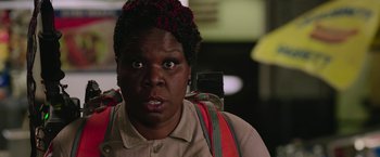 Movie still from “Ghostbusters” (2016), directed by Paul Feig – A person with a backpack is looking at the camera; Close Up shot, Over the shoulder angle