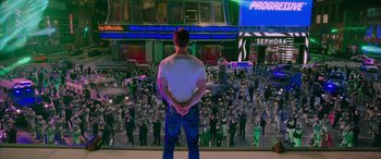 Movie still from “Ghostbusters” (2016), directed by Paul Feig – A man standing in front of a crowd of people; Wide shot, Over the shoulder angle