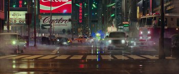 Movie still from “Ghostbusters” (2016), directed by Paul Feig – Cars driving down a street at night in the rain; Extreme Wide shot, High angle