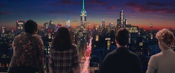 Movie still from “Ghostbusters” (2016), directed by Paul Feig – Two people looking out over a city at night; Wide shot, Over the shoulder angle