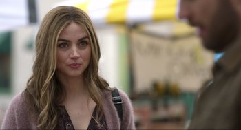 Movie still from “Ghosted” (2023), directed by Dexter Fletcher – A beautiful young woman with shoulder length brown hair; Close Up shot, Over the shoulder angle