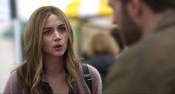 Movie still from “Ghosted” (2023), directed by Dexter Fletcher – A young woman talking to a man in a crowd of onlookers; Close Up shot, Over the shoulder angle
