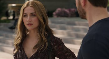 Movie still from “Ghosted” (2023), directed by Dexter Fletcher – A beautiful woman in a black and brown dress; Close Up shot, Over the shoulder angle