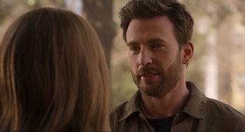 Movie still from “Ghosted” (2023), directed by Dexter Fletcher – A person talking to another person; Close Up shot, Over the shoulder angle