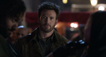 Movie still from “Ghosted” (2023), directed by Dexter Fletcher – A person wearing a jacket; Close Up shot, Over the shoulder angle