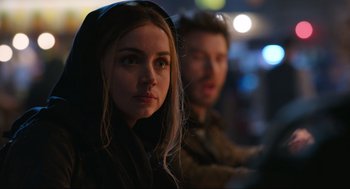 Movie still from “Ghosted” (2023), directed by Dexter Fletcher – A woman and a man standing next to each other in the dark; Close Up shot, Over the shoulder angle