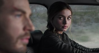 Movie still from “Ghosted” (2023), directed by Dexter Fletcher – A man and a woman sitting in the back of a car; Close Up shot, Over the shoulder angle