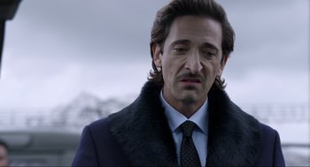 Movie still from “Ghosted” (2023), directed by Dexter Fletcher – A person wearing a suit and tie; Close Up shot, Over the shoulder angle