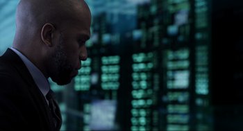 Movie still from “Ghosted” (2023), directed by Dexter Fletcher – A man with a bald head is looking at the camera; Close Up shot, Low angle