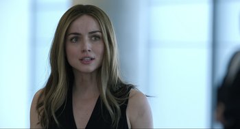 Movie still from “Ghosted” (2023), directed by Dexter Fletcher – A beautiful woman with long blonde hair wearing a black top; Close Up shot, Over the shoulder angle