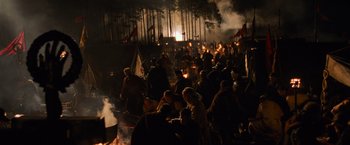Movie still from “Gladiator” (2000), directed by Ridley Scott – A group of people standing around a bonfire at night; Extreme Wide shot, High angle