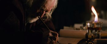 Movie still from “Gladiator” (2000), directed by Ridley Scott – An older man writing on a piece of paper; Close Up shot, Low angle