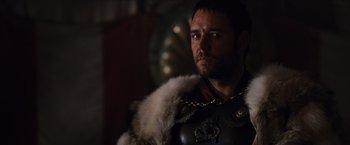 Movie still from “Gladiator” (2000), directed by Ridley Scott – A person wearing a suit of armor; Close Up shot, Over the shoulder angle