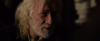 Movie still from “Gladiator” (2000), directed by Ridley Scott – An old man with white hair and a long beard; Close Up shot, Over the shoulder angle