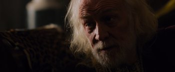 Movie still from “Gladiator” (2000), directed by Ridley Scott – An old man with long white hair and a beard; Close Up shot, Over the shoulder angle