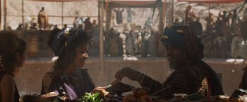 Movie still from “Gladiator” (2000), directed by Ridley Scott – A man and a woman sitting at a table with food; Medium shot, Over the shoulder angle