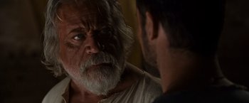 Movie still from “Gladiator” (2000), directed by Ridley Scott – An older man with a beard looking at a younger man; Close Up shot, Over the shoulder angle