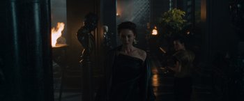 Movie still from “Gladiator” (2000), directed by Ridley Scott – A woman in a black dress standing next to a statue; Medium shot, Over the shoulder angle