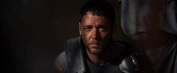 Movie still from “Gladiator” (2000), directed by Ridley Scott – A person wearing a helmet; Close Up shot, Over the shoulder angle