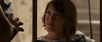 Movie still from “Gladiator” (2000), directed by Ridley Scott – A young girl is standing behind bars in a jail cell; Close Up shot, High angle