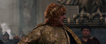 Movie still from “Gladiator” (2000), directed by Ridley Scott – A person wearing a costume; Close Up shot, Over the shoulder angle