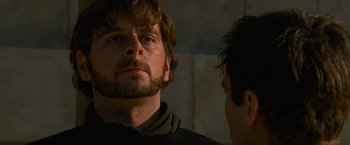 Movie still from “Gladiator” (2000), directed by Ridley Scott – A man with a beard looking at another man with a beard; Close Up shot, Over the shoulder angle
