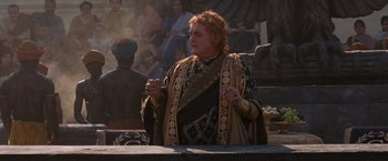 Movie still from “Gladiator” (2000), directed by Ridley Scott – An older woman wearing a crown is holding a spoon; Medium shot, Over the shoulder angle