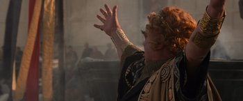 Movie still from “Gladiator” (2000), directed by Ridley Scott – A woman in a costume is raising her hands; Close Up shot, Low angle