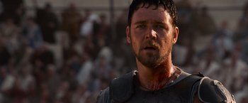 Movie still from “Gladiator” (2000), directed by Ridley Scott – A person with blood all over his face; Close Up shot, Low angle