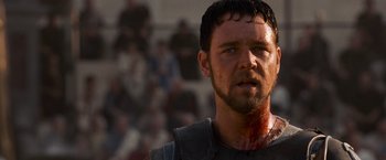 Movie still from “Gladiator” (2000), directed by Ridley Scott – A person with blood all over his face; Close Up shot, Low angle