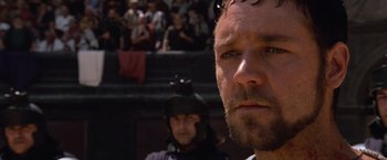 Movie still from “Gladiator” (2000), directed by Ridley Scott – A person with a helmet on; Close Up shot, Over the shoulder angle
