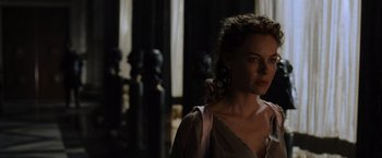 Movie still from “Gladiator” (2000), directed by Ridley Scott – A woman standing in front of some statues; Close Up shot, Over the shoulder angle