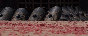 Movie still from “Gladiator” (2000), directed by Ridley Scott – A group of black and gold helmets sitting on top of a floor; Close Up shot, High angle