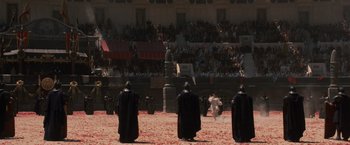 Movie still from “Gladiator” (2000), directed by Ridley Scott – A group of men in black robes standing in front of an audience; Extreme Wide shot, High angle