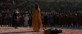 Movie still from “Gladiator” (2000), directed by Ridley Scott – A crowd of people watching a man lying on the ground; Wide shot, High angle