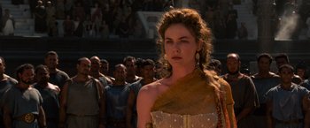 Movie still from “Gladiator” (2000), directed by Ridley Scott – A woman standing in front of a group of people; Medium shot, Over the shoulder angle