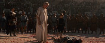 Movie still from “Gladiator” (2000), directed by Ridley Scott – A man and a woman standing next to a dead body; Wide shot, High angle
