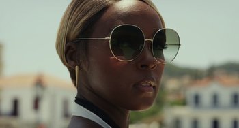 Movie still from “Glass Onion” (2022), directed by Rian Johnson – A person wearing sunglasses; Close Up shot, Low angle