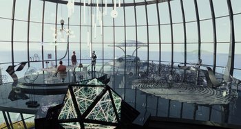 Movie still from “Glass Onion” (2022), directed by Rian Johnson – People are standing in front of a large glass window; Extreme Wide shot, High angle